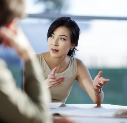 A woman talking to a person in an office